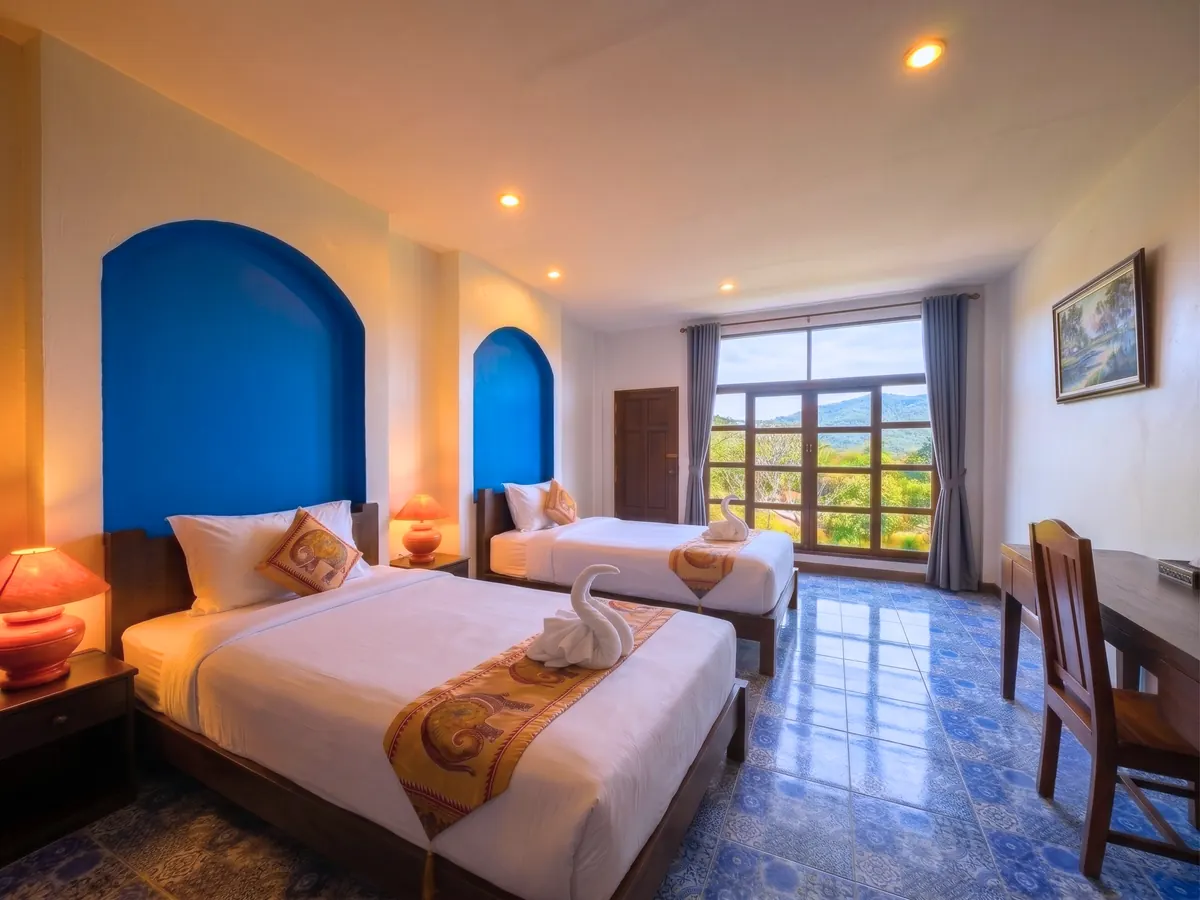 Studio with Mountain View — twin bed configuration with mountain view.